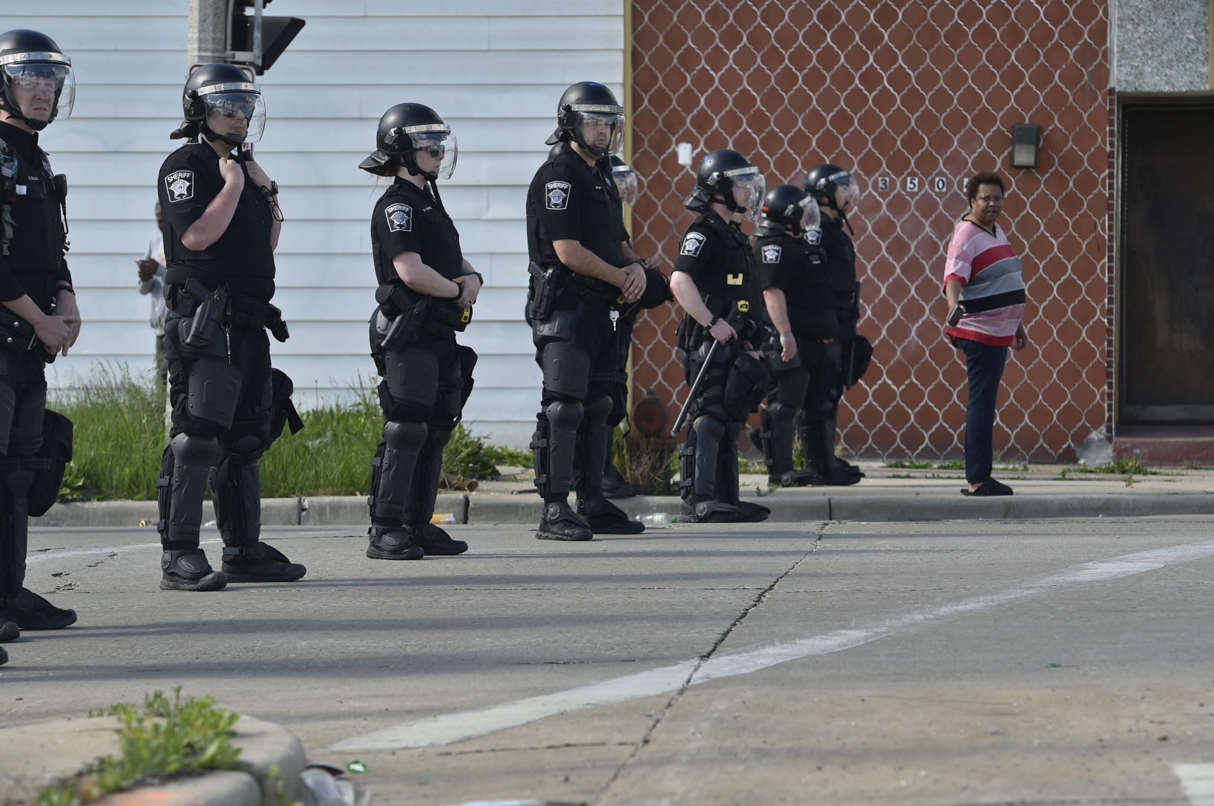 Law enforcement officers stand silent